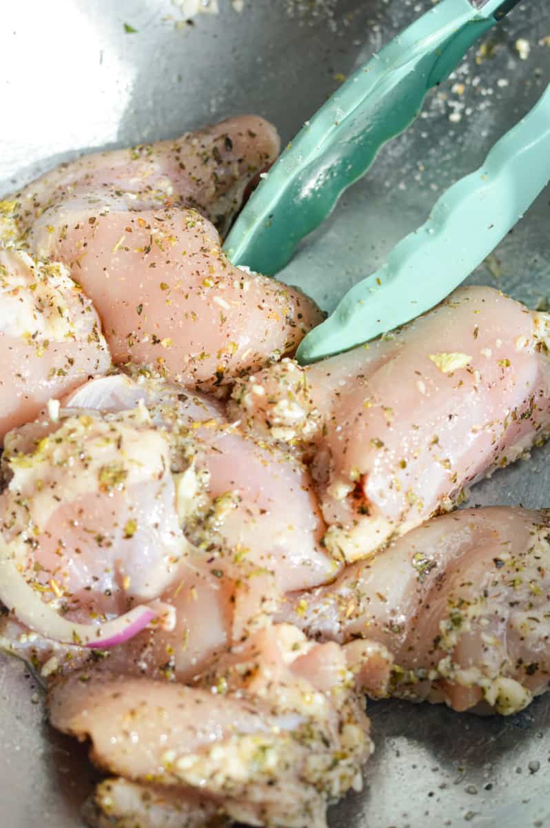 Seasoning chicken thighs.