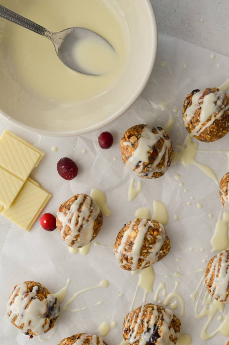 cranberry orange bliss balls drizzled with white chocolate