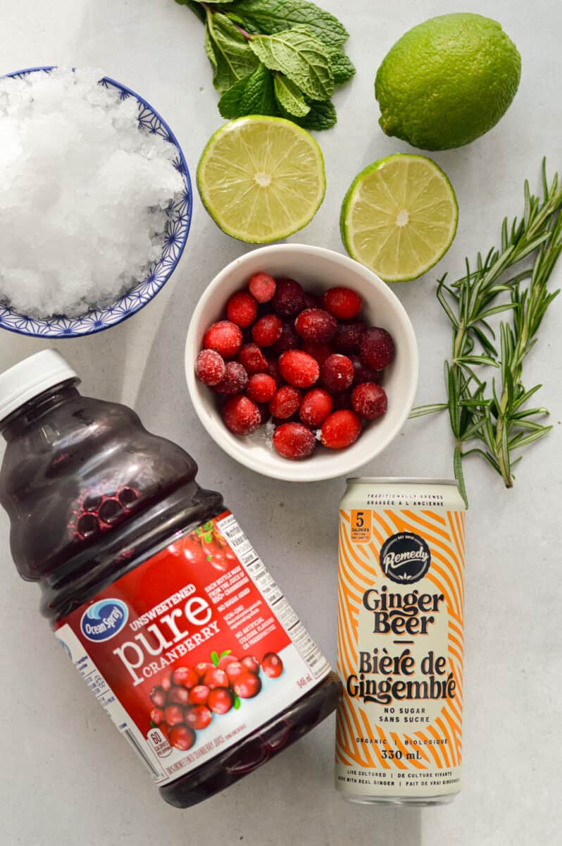 Ingredients including cranberry juice, frozen cranberries, lime, ginger beer, mint, soda water and crushed ice.