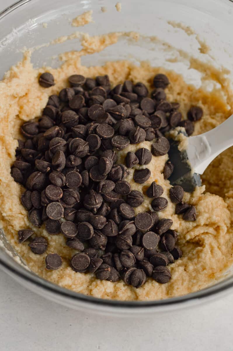 Adding chocolate chips to muffin batter.