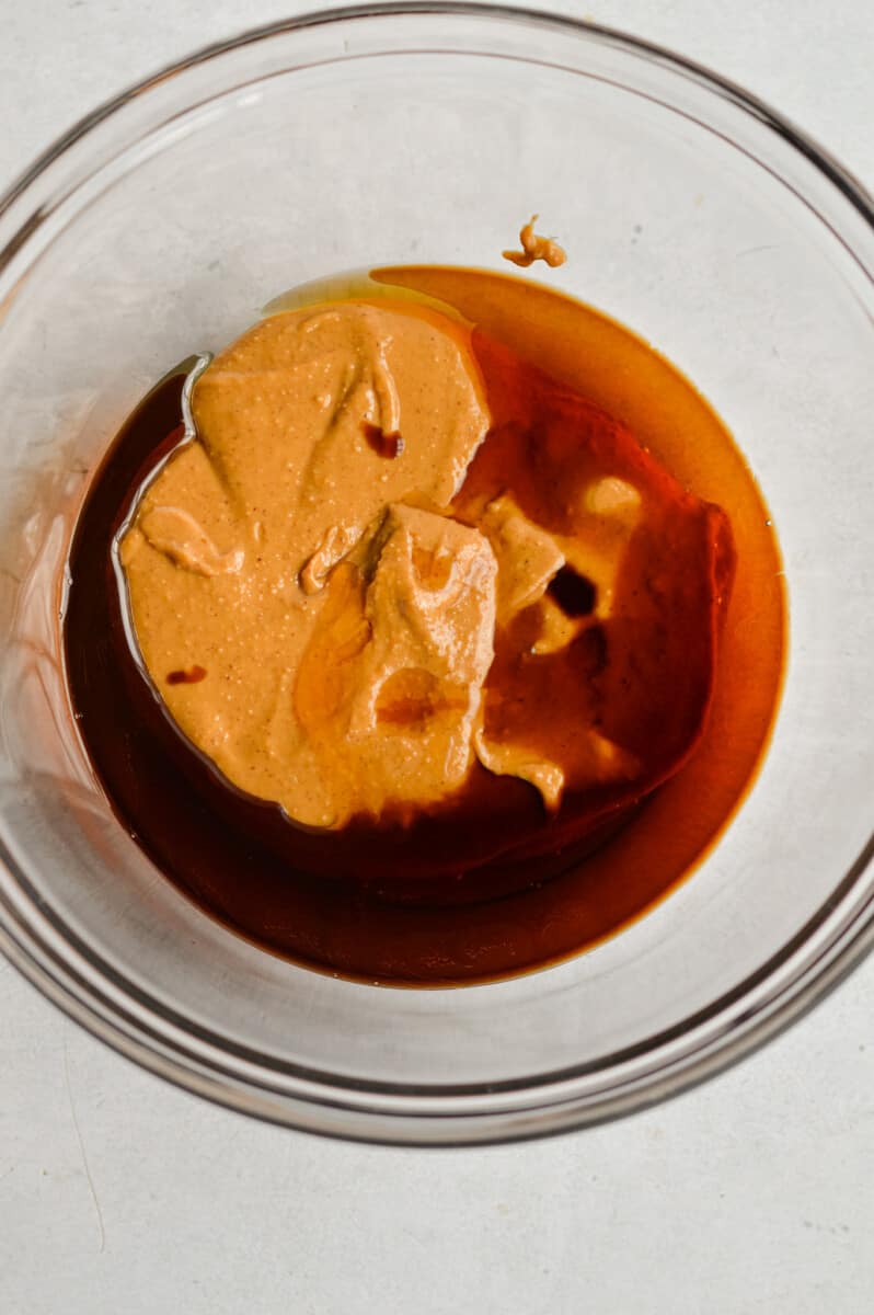 Mixing together peanut butter, maple syrup, vanilla extract and salt until smooth. 