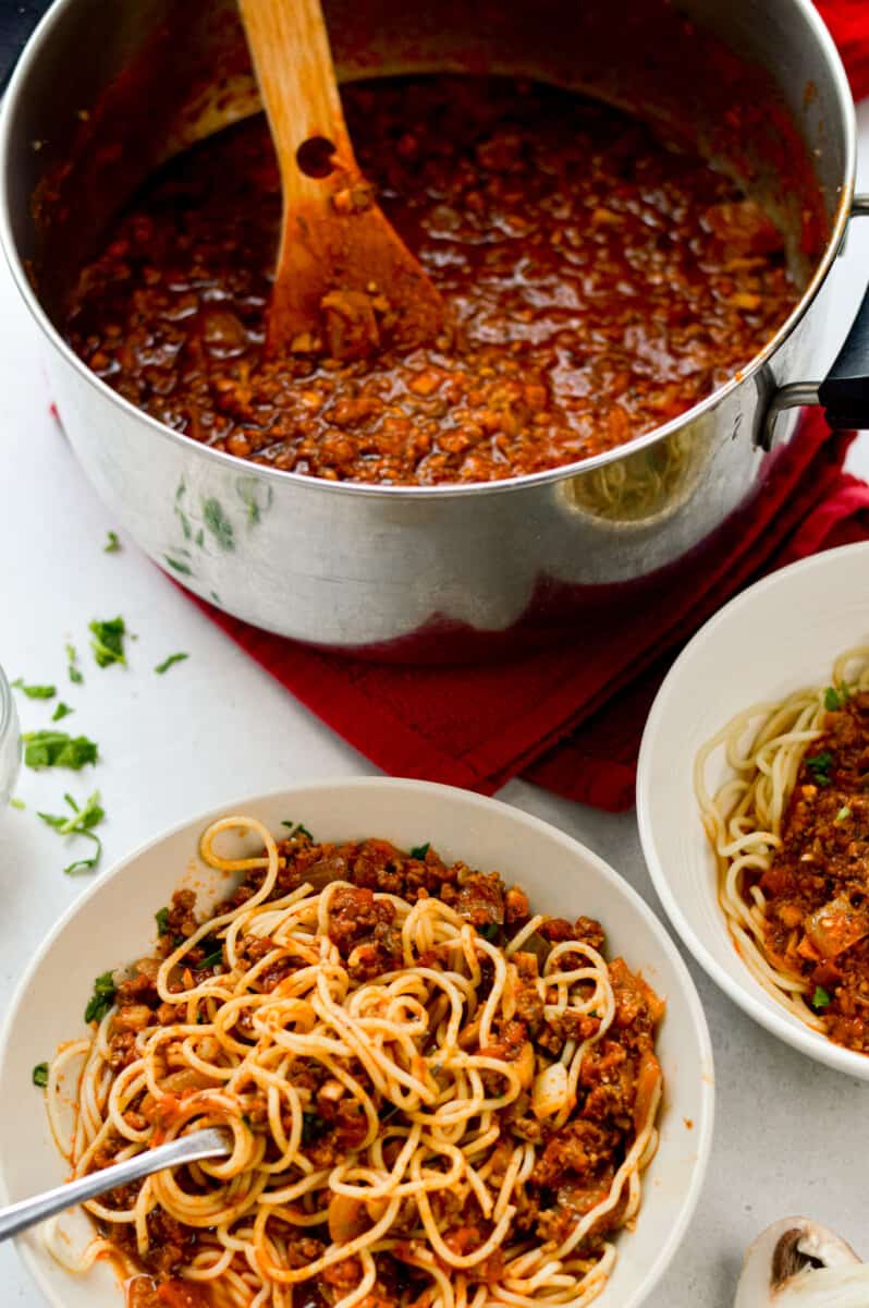 Serving plates of pasta with mushroom spaghetti sauce.