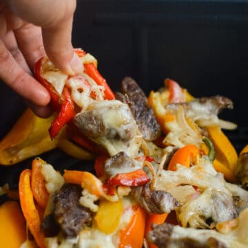 air fryer philly cheesesteak stuffed pepper cheese pull close up
