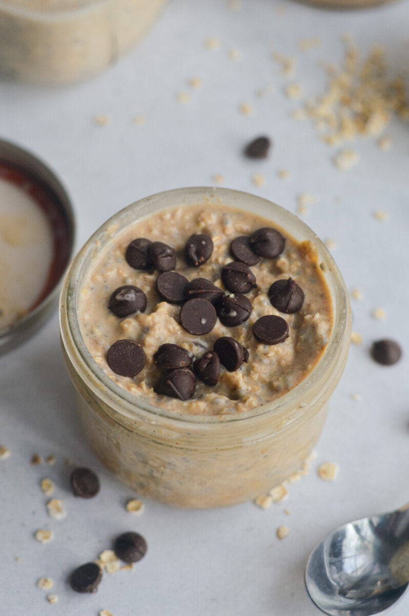 Jar of cookie dough overnight oats topped with chocolate chips.