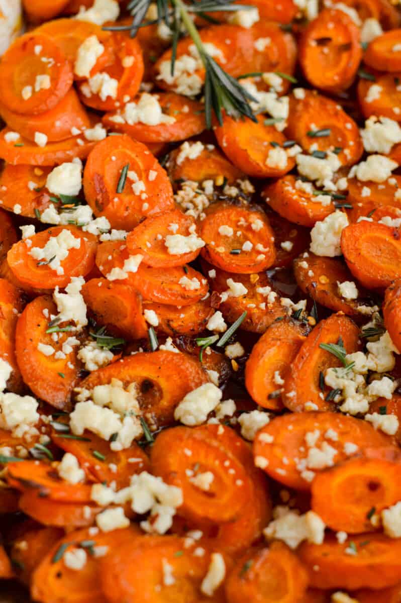 Close up of spicy hot honey carrots with feta and rosemary.