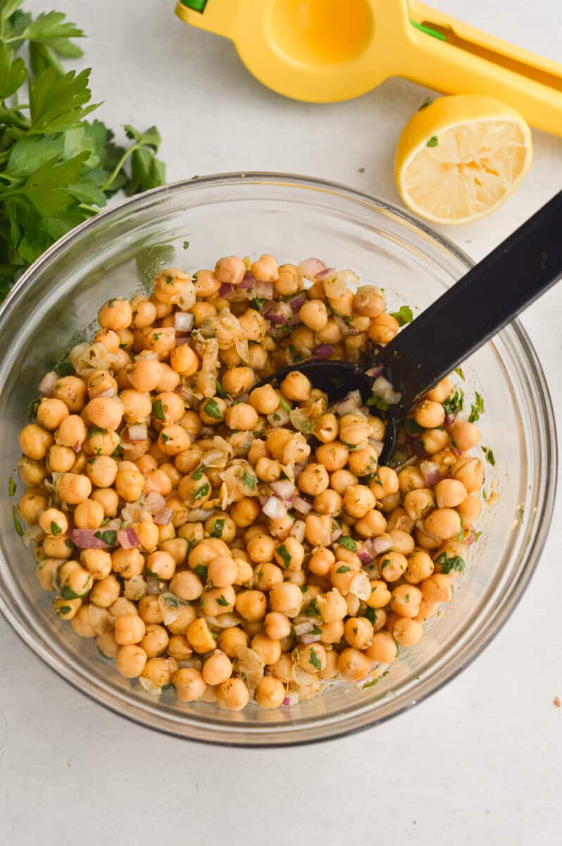 Mixing Greek marinated chickpeas.