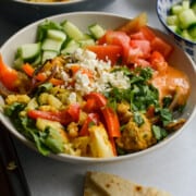 Chicken shawarma bowl with veggies, feta chees, cilantro and served with fresh pita.