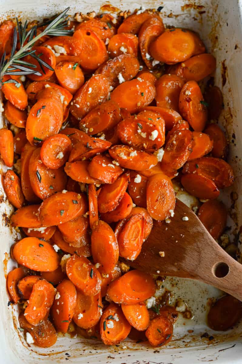 Stirring hot honey roasted carrots.