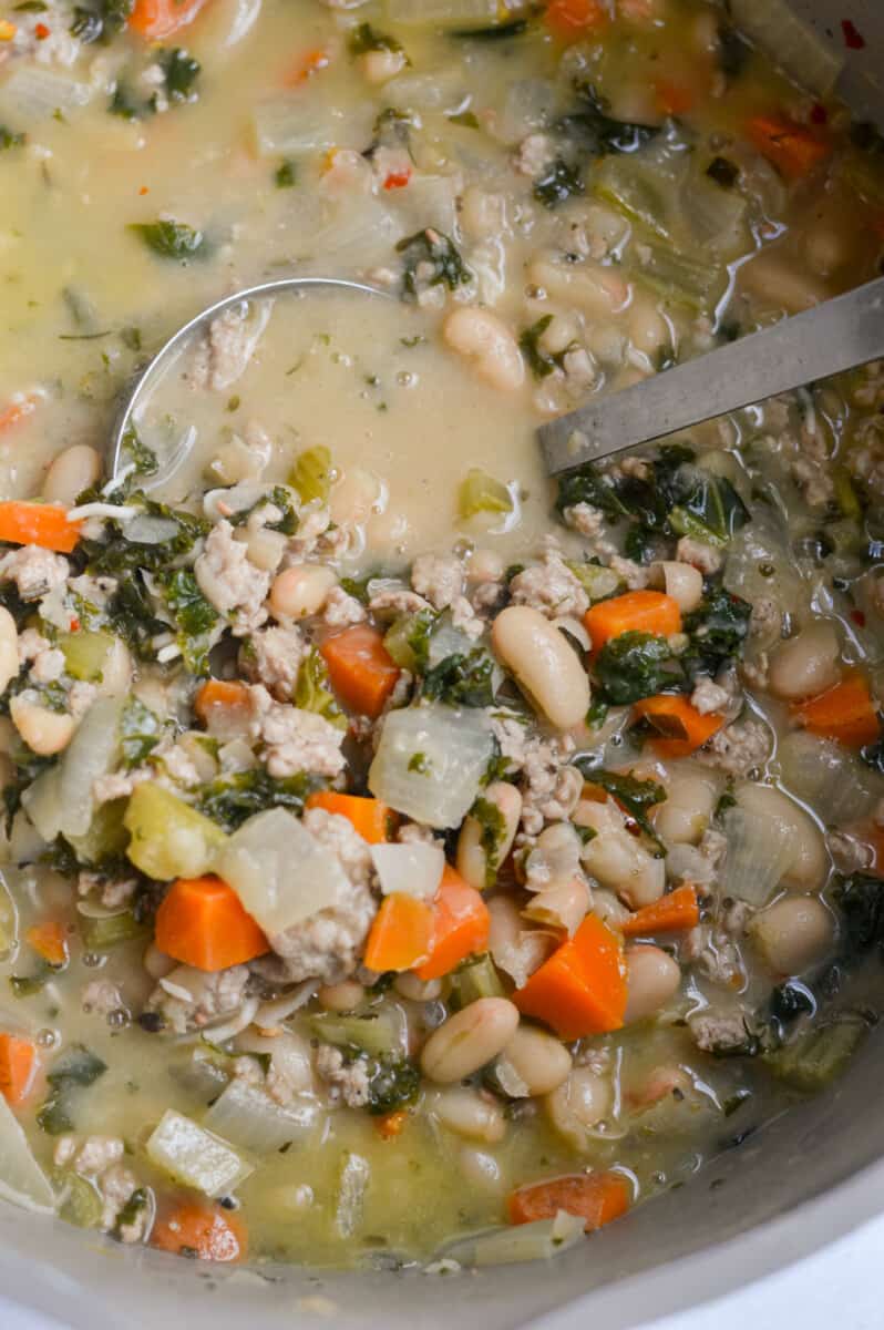 Stirring lemon white bean soup with turkey and greens.