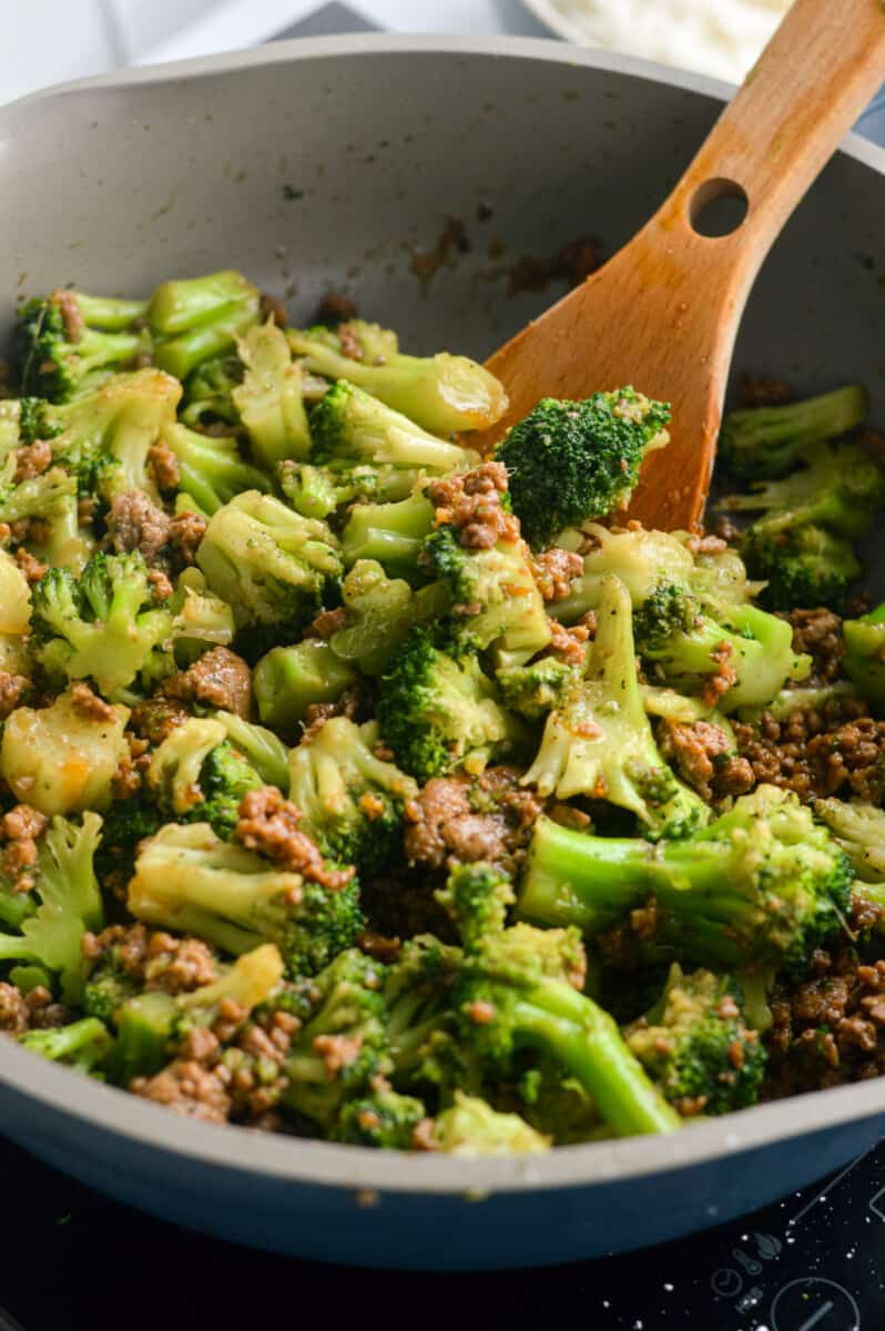 Stir frying ground beef and broccoli.