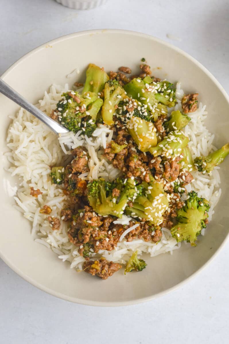 Bowl of ground beef and broccoli served on rice.