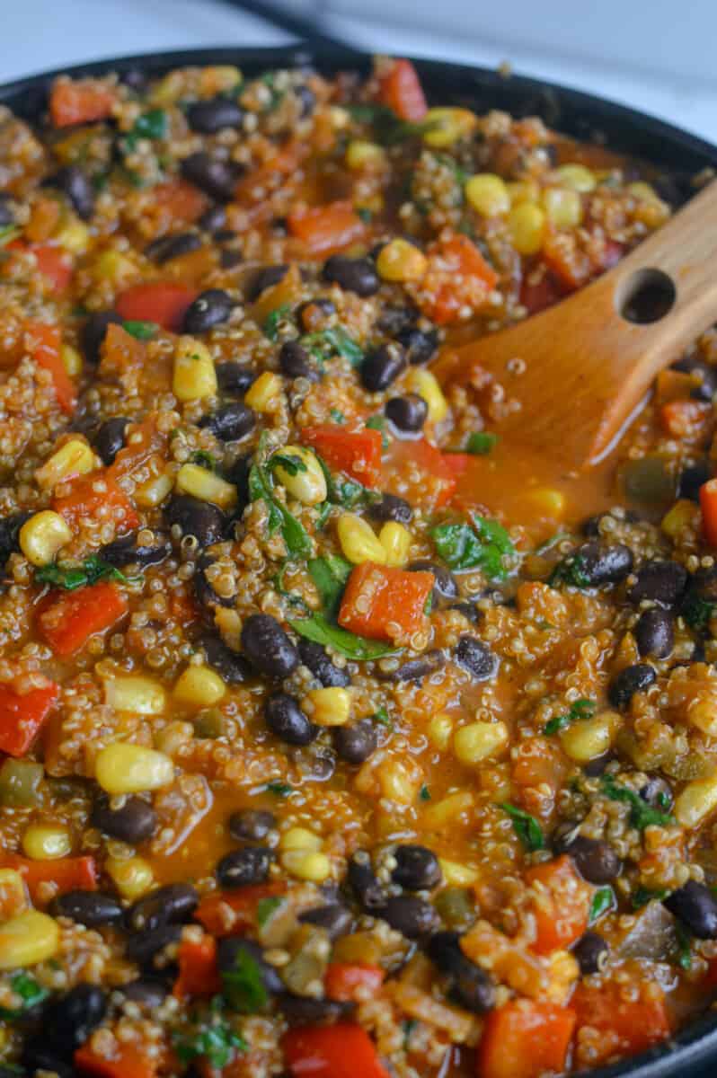Stirring taco skillet with beans, corn, and cilantro.
