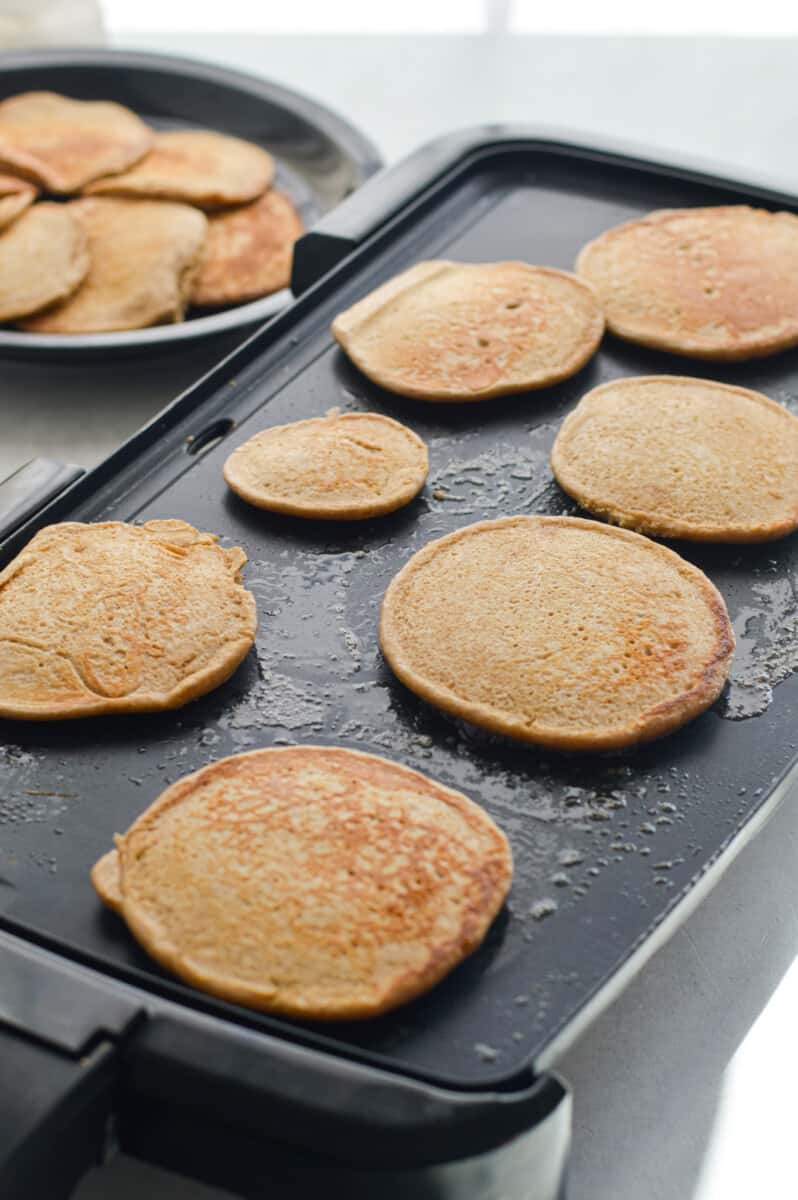 Cooking cottage cheese protein pancakes on a griddle.