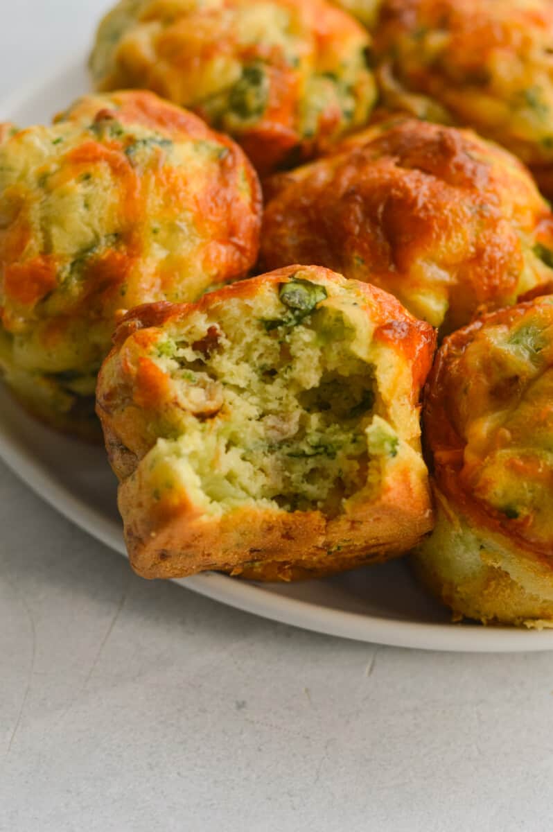 Close up of savory cottage cheese muffins with a bite.