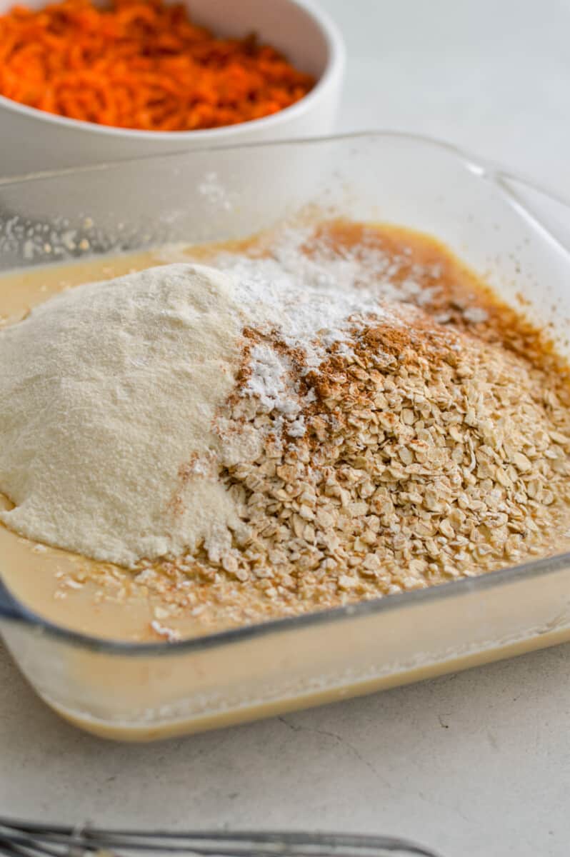 Adding oats, collagen, baking powder, cinnamon, salt and ground ginger to wet ingredients.
