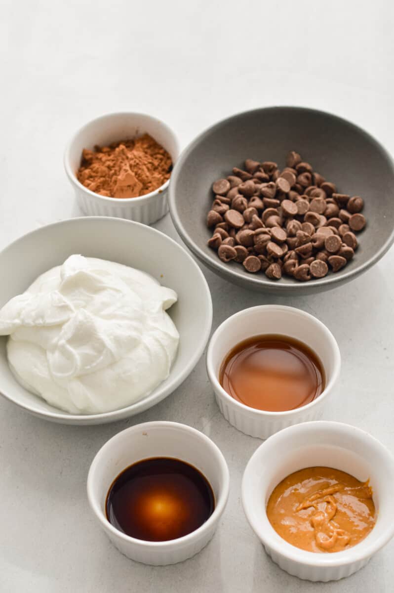 Ingredients including plain Greek yogurt, chocolate chips, cocoa powder, vanilla, maple syrup and peanut butter.