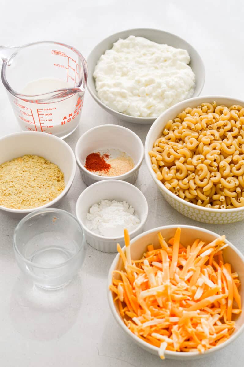 Ingredients including cottage cheese, shredded cheese, pasta, spices, nutritional yeast, cornstarch, milk and pasta water.