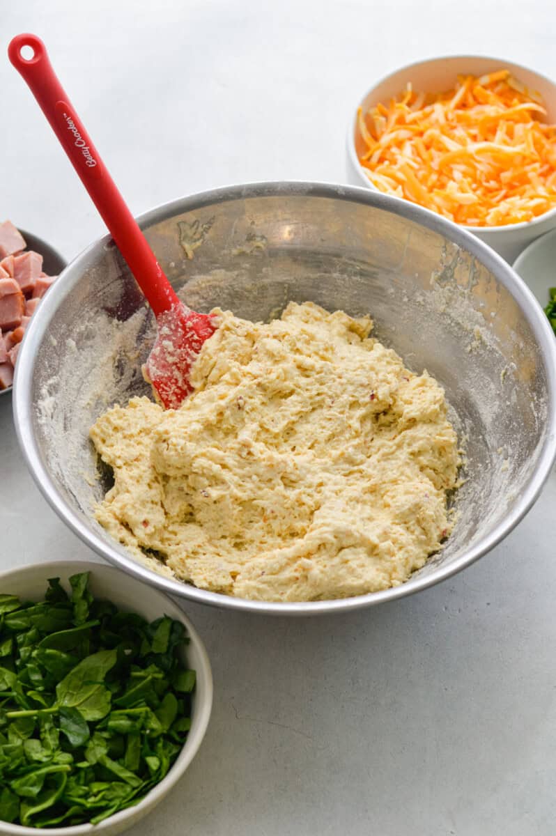 Mixing ingredients to form a biscuit dough.