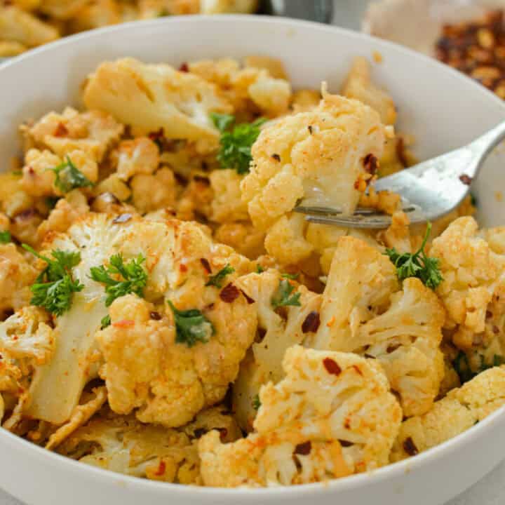 Spicy Parmesan Roasted Cauliflower with Tahini Sauce - Nourished by Nic