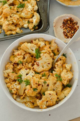 Spicy Parmesan Roasted Cauliflower with Tahini Sauce - Nourished by Nic