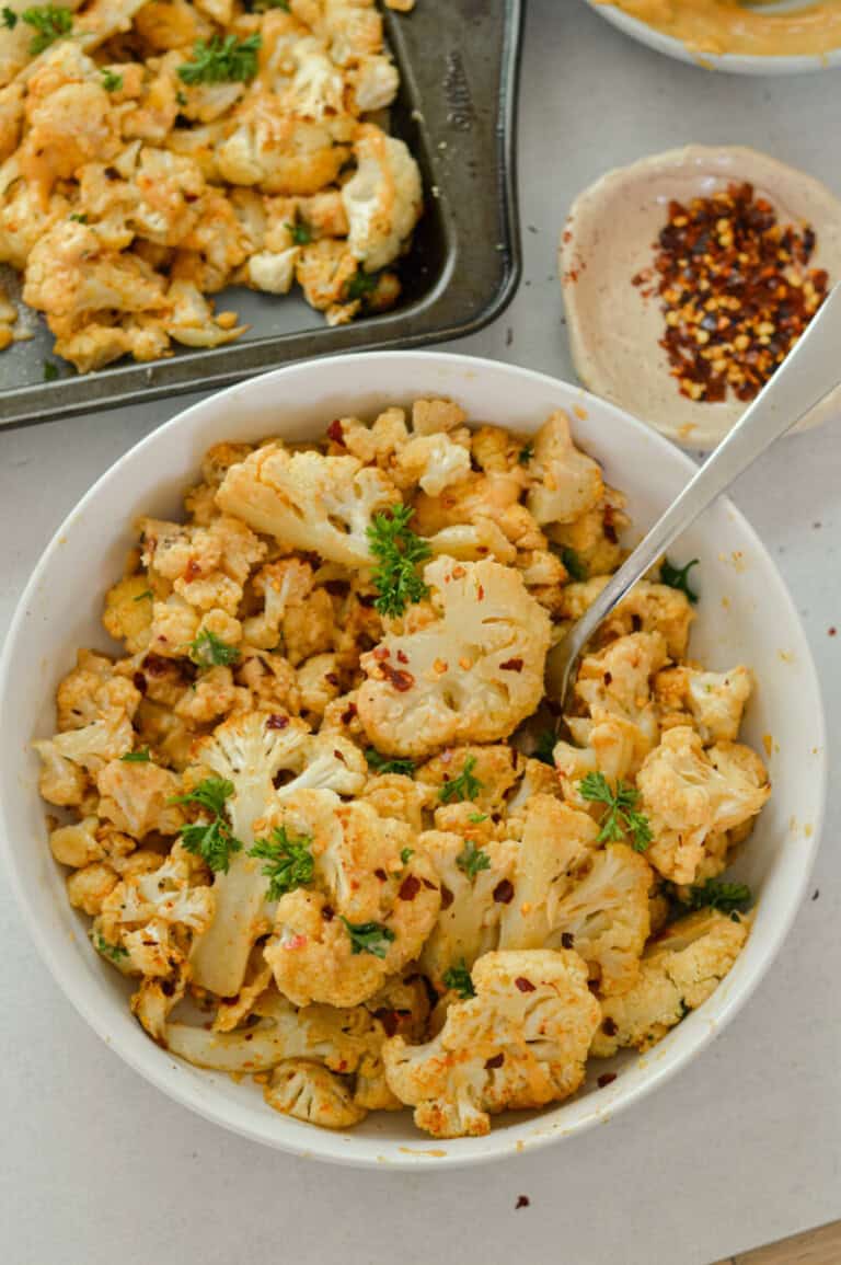 Spicy Parmesan Roasted Cauliflower with Tahini Sauce - Nourished by Nic