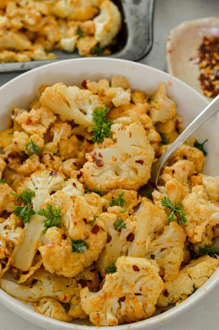 Spicy Parmesan Roasted Cauliflower with Tahini Sauce - Nourished by Nic