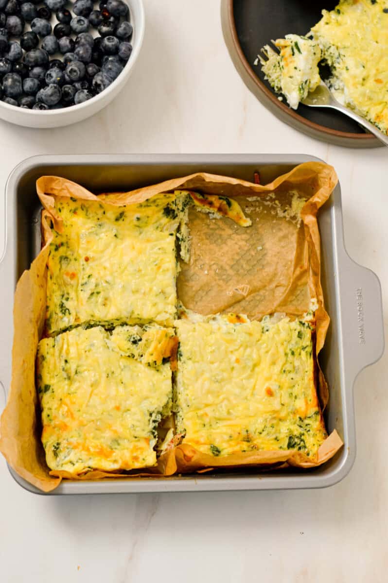 Cooked casserole with one slice removed from the baking dish