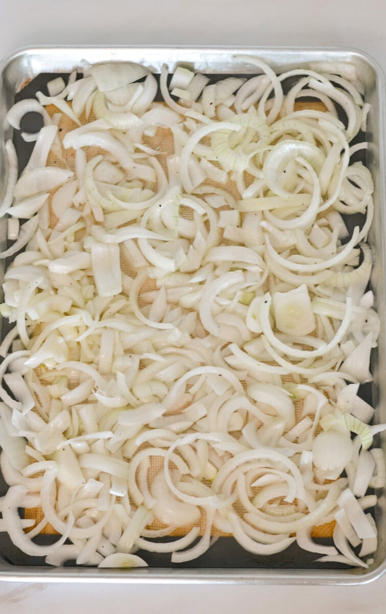 Sliced onion spread on a baking dish