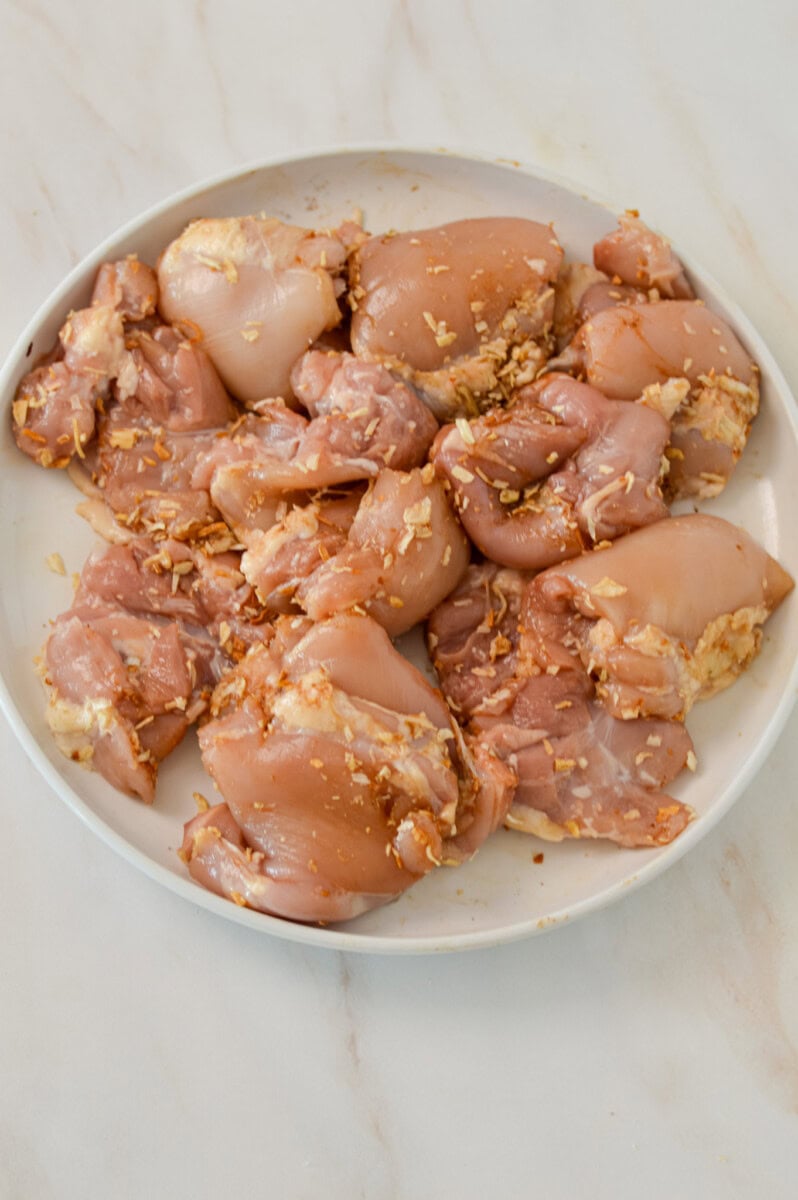 Chicken thighs on a plate covered with onion soup mix