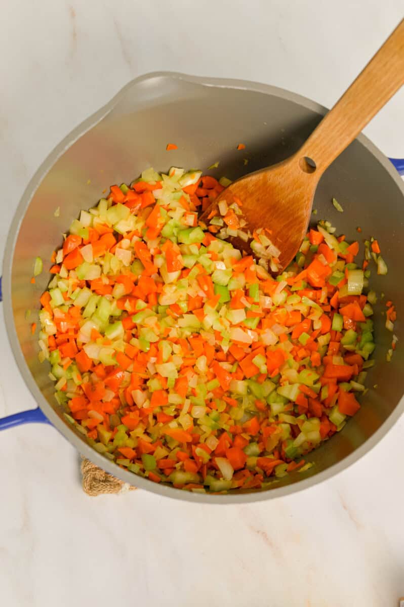Mirepoix being sauteed in a large pot