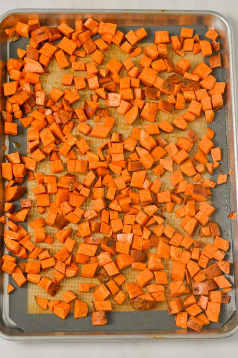 Sweet potatoes diced on a sheet pan