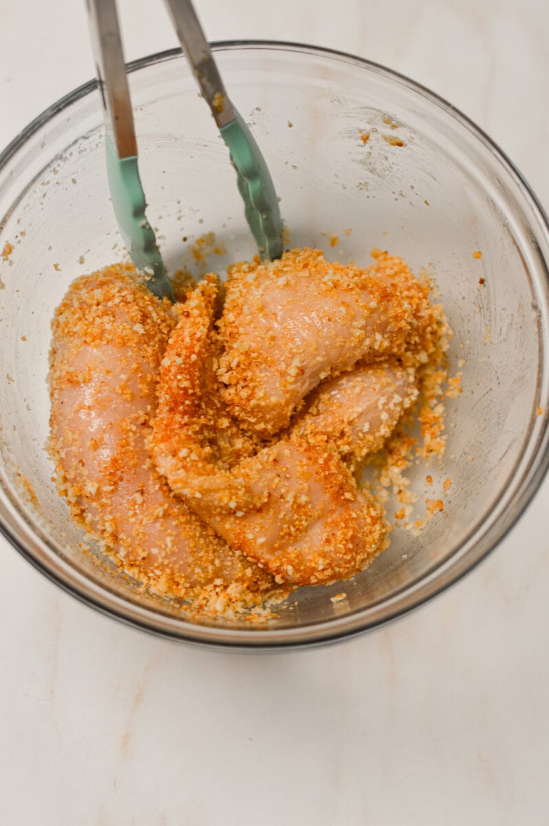 Chicken breasts tossed with the breadcrumbs, spices and dijon mustard in a large bowl
