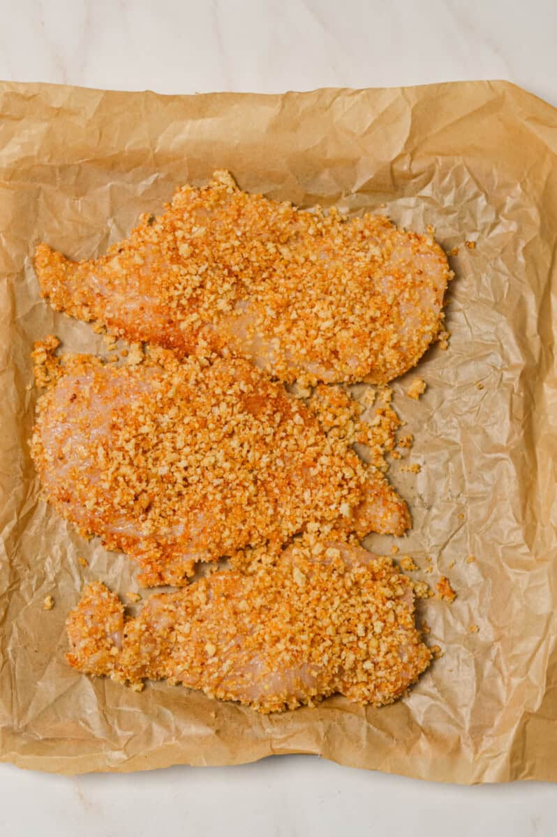 Chicken breasts laid out on an air fryer tray