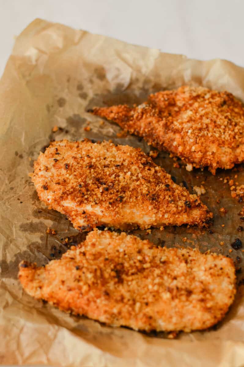 Fully cooked crispy baked chicken on an air fryer tray
