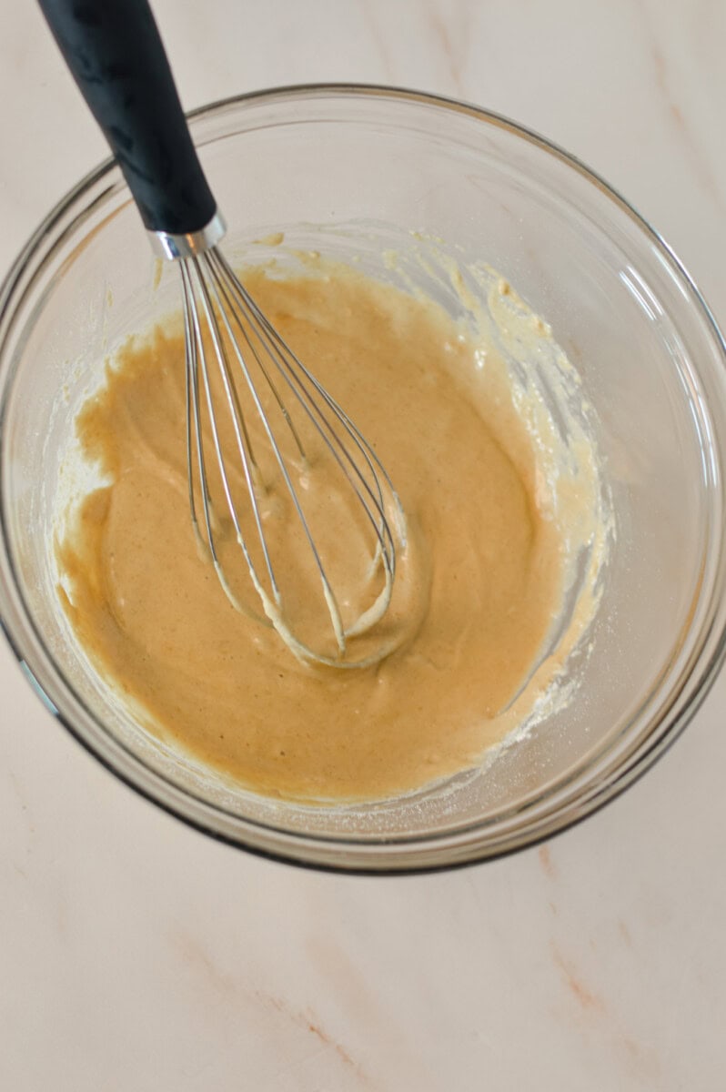 Ingredients combined in a mixing bowl with a whisk
