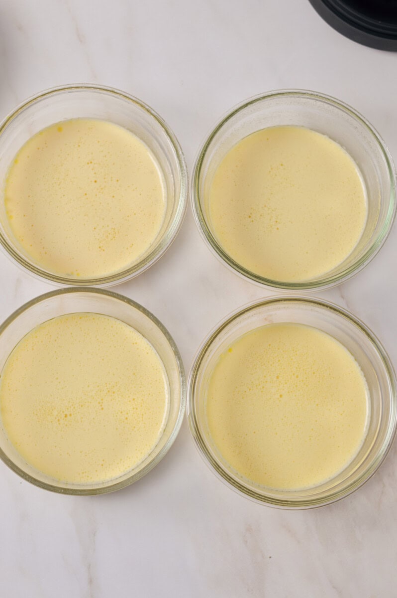 Egg mixture separated into individual bowls