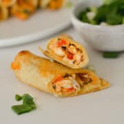 Close up of a baked taquito sliced in half