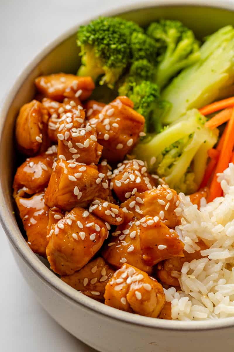 Close up of chicken over rice with vegetables