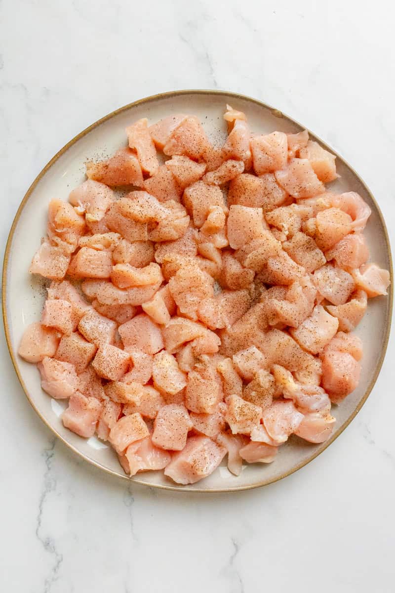 Cubed raw chicken breast on a plate