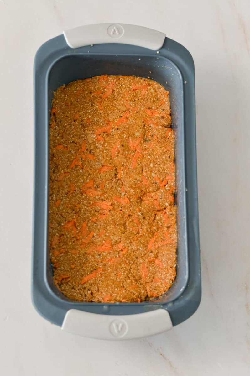 Carrot cake bar base pressed into a silicone tray