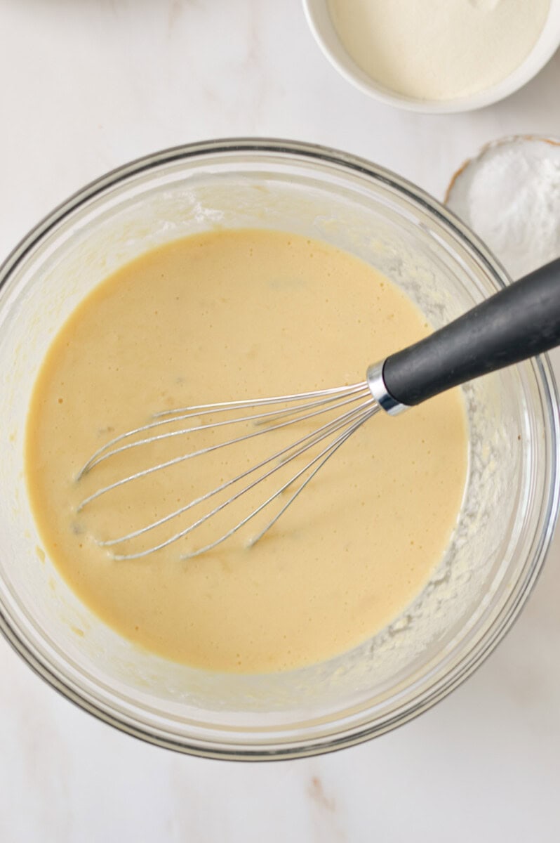 Wet ingredients being whisked in a bowl