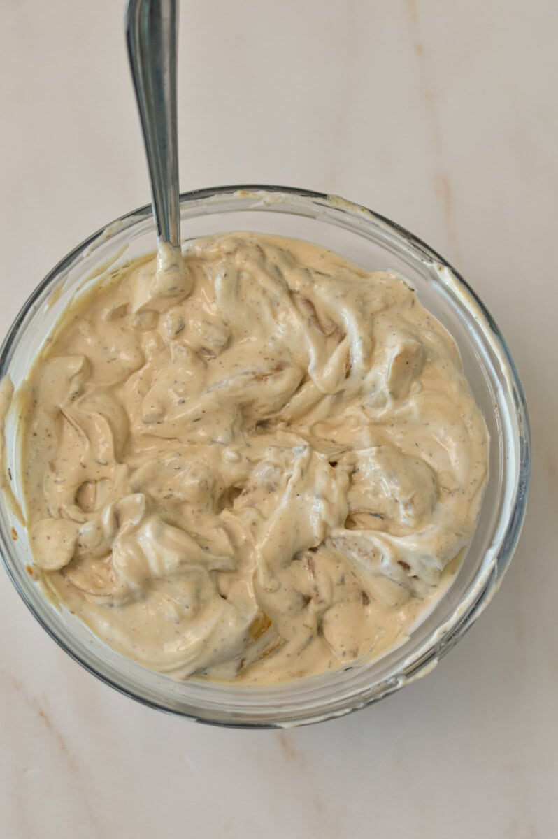 Onions mixed in with Greek yogurt in a bowl
