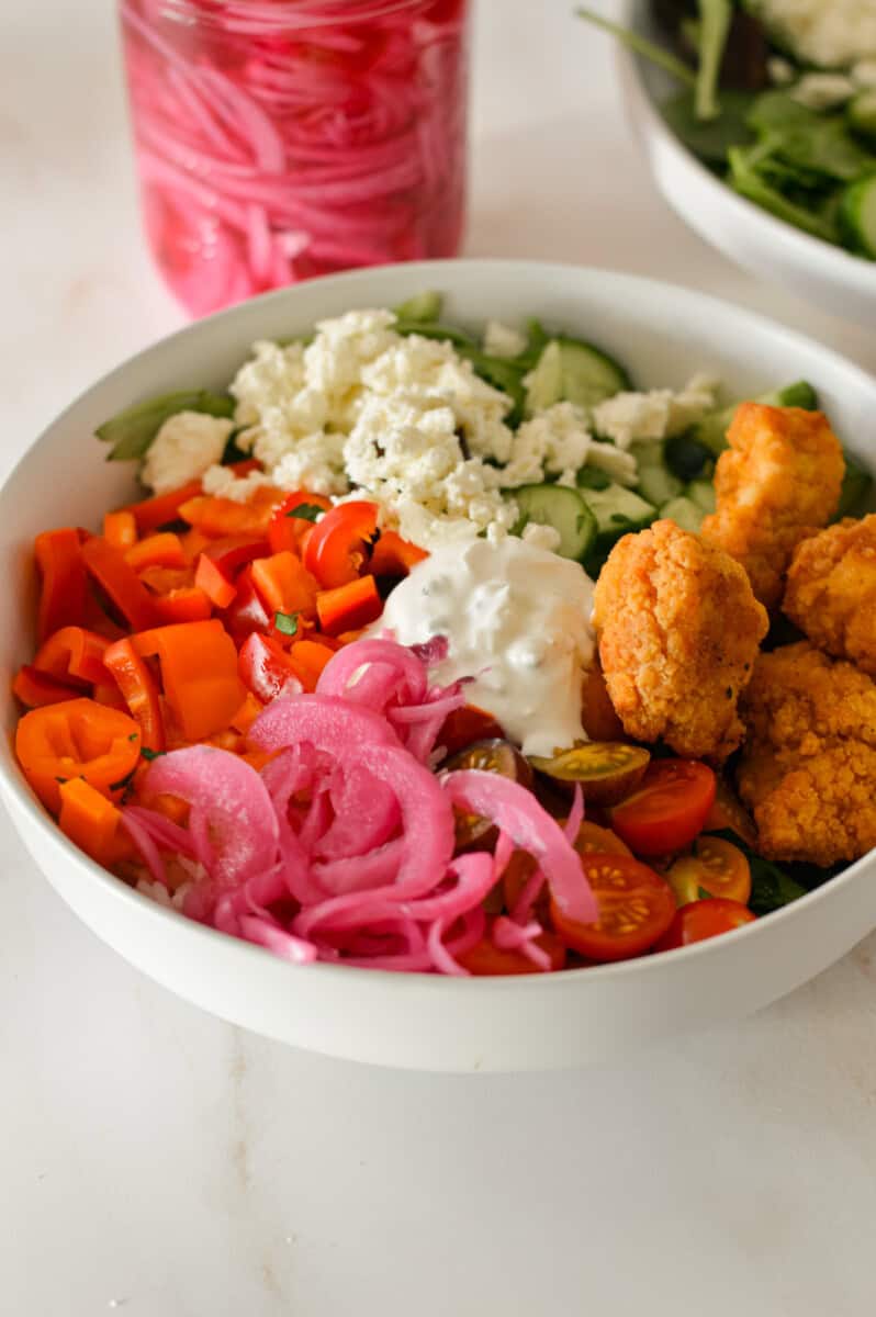 Pickled onions added as a topping to a grain bowl