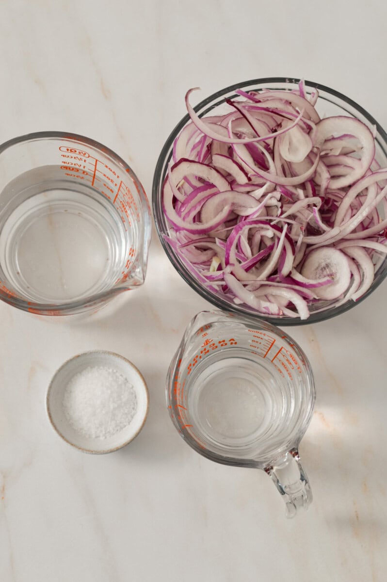 Ingredients for pickled onions including red onion, distilled water, white vinegar and salt