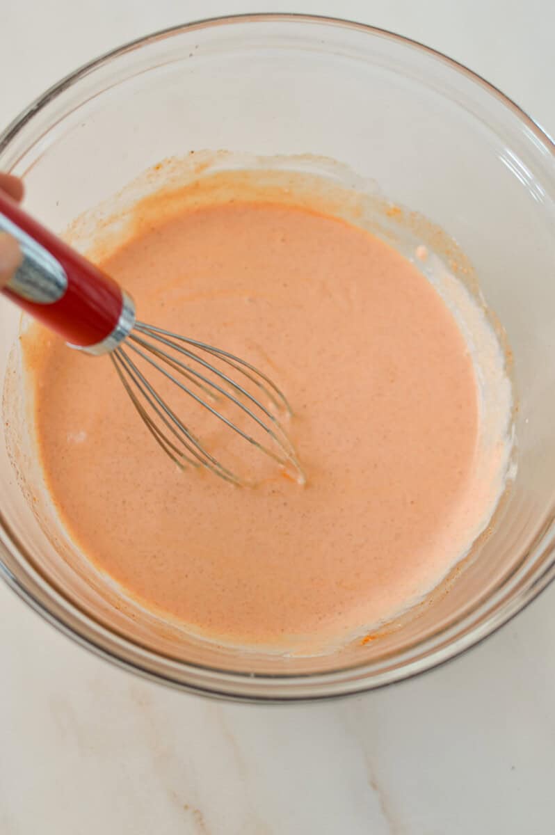 Sauce being whisked in a bowl