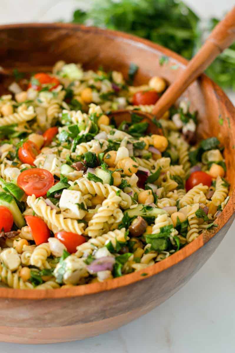 Close up of chickpea pasta salad in a large serving bowl.
