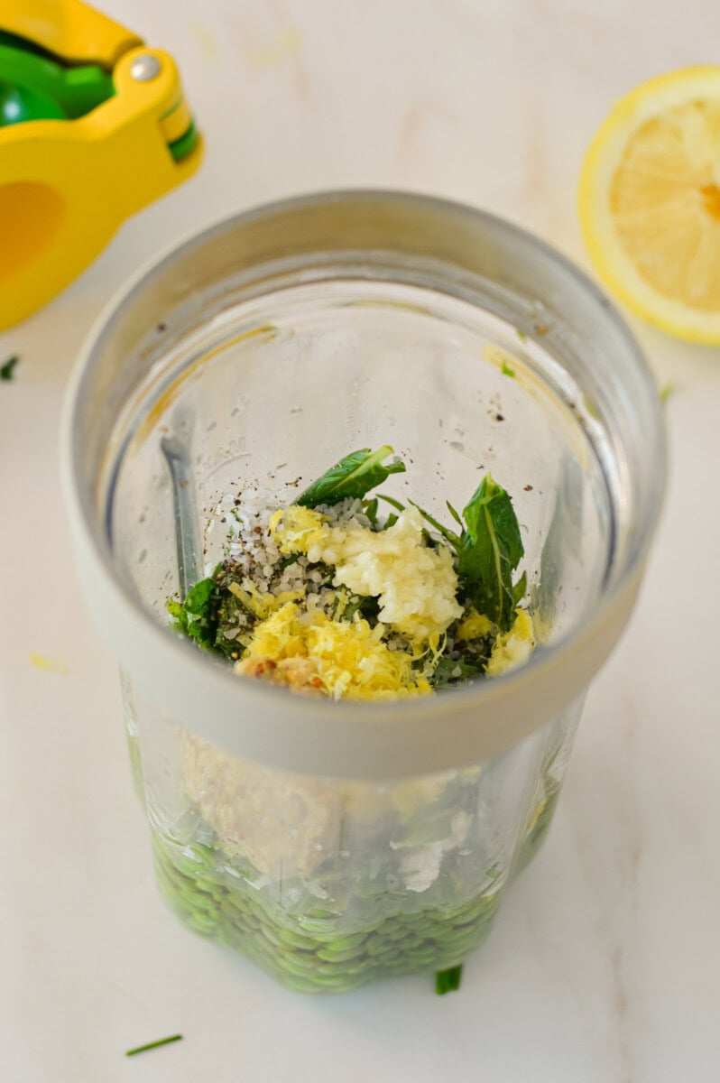 Ingredients for pea hummus in a blender.
