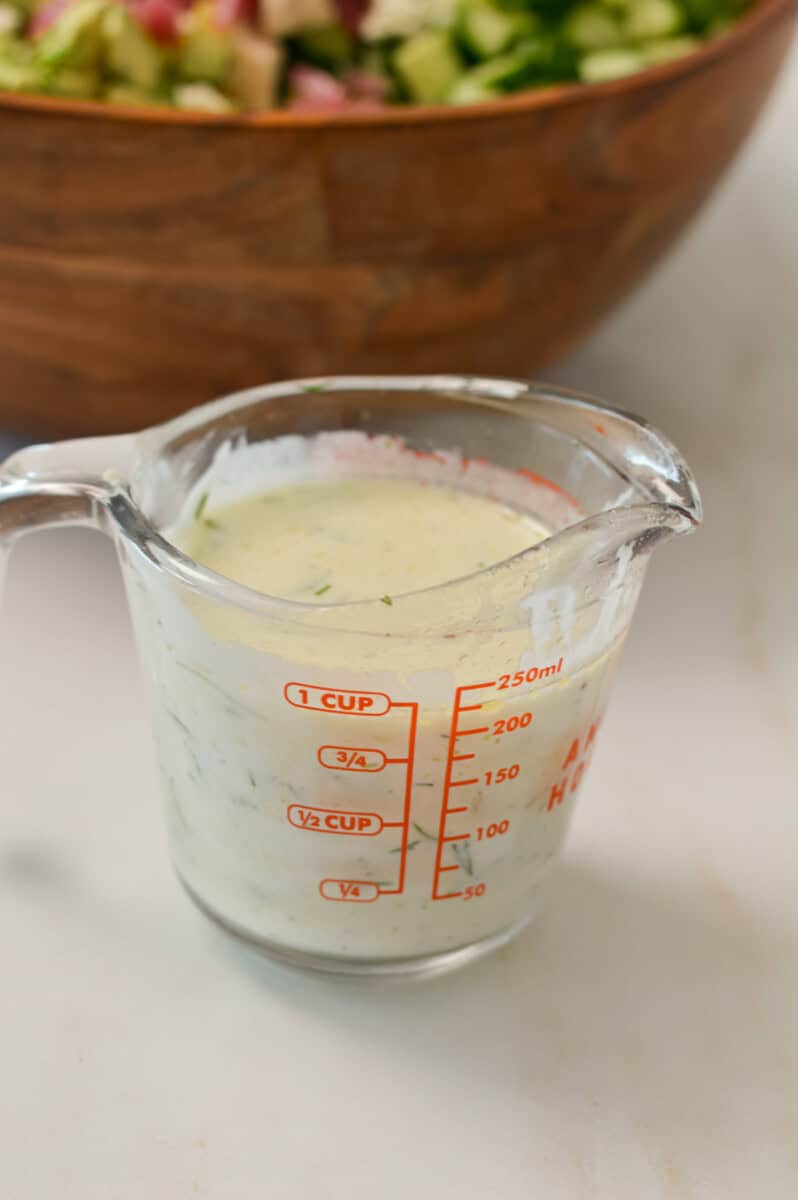 homemade Greke yogurt tzatziki dresssing in a measuring cup