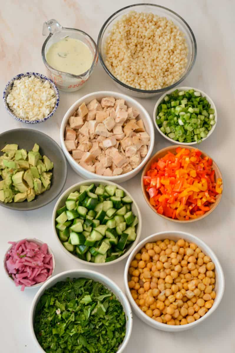 fresh ingredients prepared for mediterannean pearl couscous salad