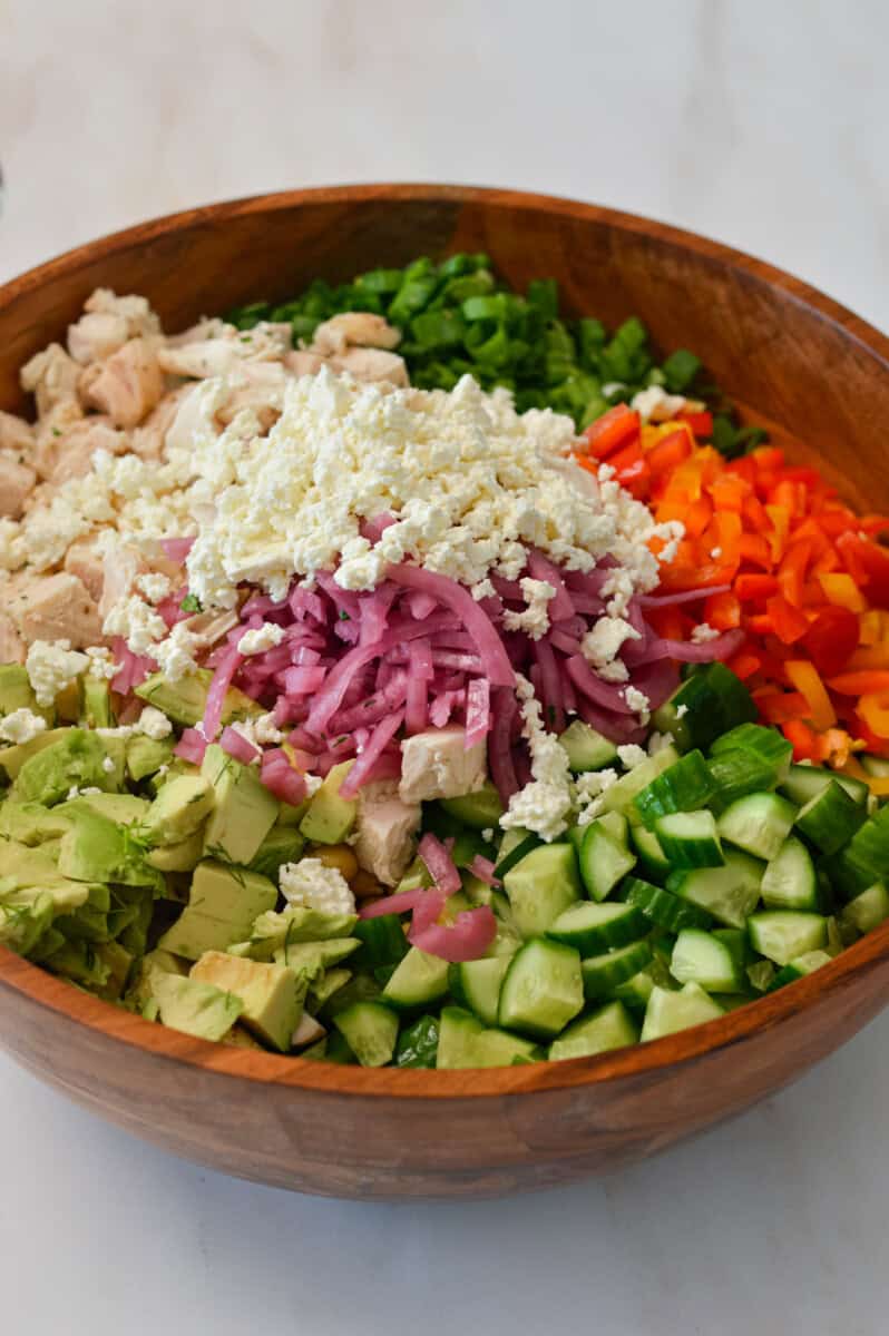 ingredients for pearl couscous salad in a wooden bowl